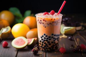Iced bubble tea with tapioca pearls and fresh fruits displayed on rustic wooden table photo