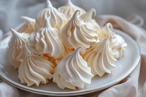 Delicious meringues resting on elegant plate, tempting dessert presentation photo