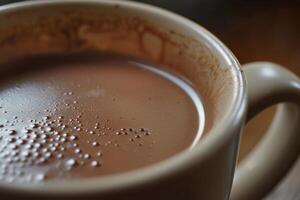 Steaming hot chocolate in ceramic mug creating tiny bubbles photo