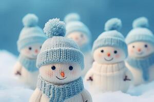 Smiling snowmen wearing knitted hats and scarves enjoying winter wonderland photo