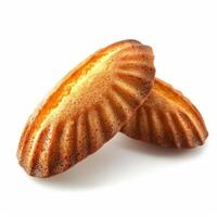 Two golden shell shaped madeleines resting on white background photo