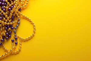 Mardi gras beads on yellow background creating festive atmosphere photo