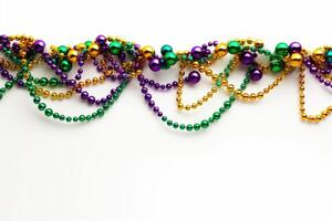 Mardi gras beads hanging on white background creating festive atmosphere photo