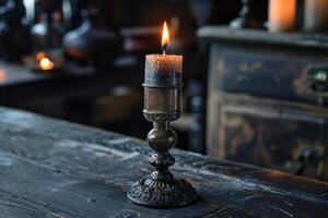 Burning candle on a vintage candlestick creating a warm ambiance in a rustic setting photo