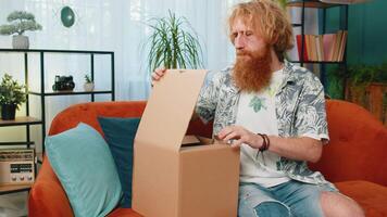 Angry dissatisfied shopper Caucasian man unpacking parcel feeling upset, confused, wrong delivery video