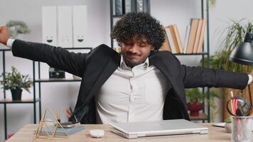 Indian business man freelancer at office, start working on laptop computer, sends online messages video