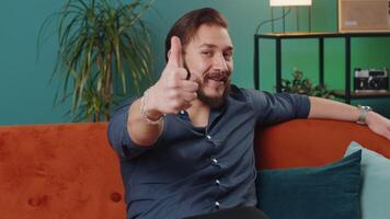 Happy lebanese man looking approvingly at camera showing thumbs up, like positive sign, good news video