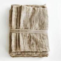 Folded linen fabric tied with a string on white background photo