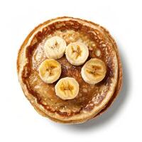 Stack of pancakes with sliced bananas and syrup drizzled on top photo