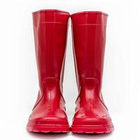 Pair of red rubber boots standing on white background photo