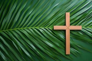 Wooden christian cross resting on palm leaves symbolizing palm sunday photo