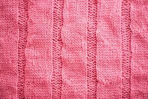 Pink knitted cable pattern showing soft texture ideal for backgrounds photo