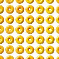 Rows of delicious yellow iced ring donuts creating a pattern photo