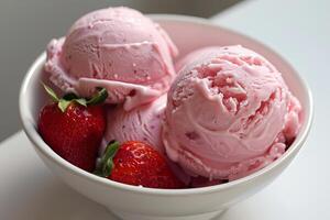 Strawberry ice cream scoops with fresh strawberries in a bowl photo