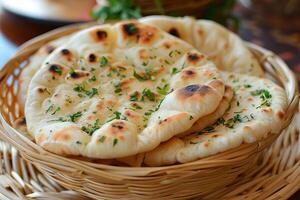 Freshly baked naan bread garnished with parsley in a basket photo