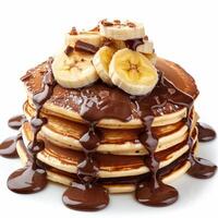 Stack of pancakes dripping with chocolate and topped with banana slices photo