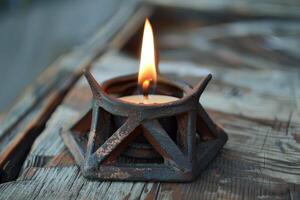 Burning candle creating warm atmosphere on rustic wooden table photo