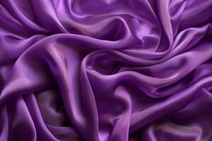 Purple fabric flowing and waving with highlights and shadows creating an abstract background photo