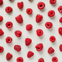 Fresh raspberries arranged on white background creating vibrant pattern photo