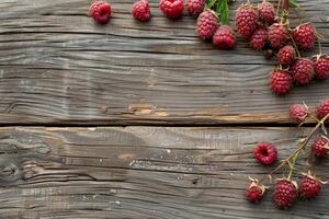 Fresh raspberries lying on rustic wooden table background photo