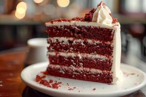 Delicious red velvet cake showing layers on white plate in cafe photo