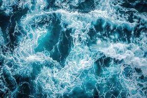 Deep blue ocean water with white foaming waves creating stunning patterns photo