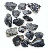 Black stones showing unique patterns lying on white background photo