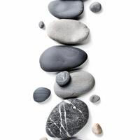 Balancing pebbles creating a serene vertical composition on white background photo