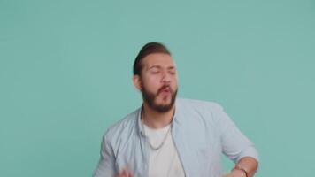 Lebanese man having fun dancing, moving to rhythm, dabbing raising hands, making dub dance gesture video