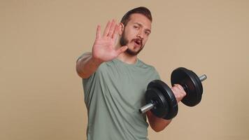 Athlete sportive man say no hold hand palm in stop gesture, warning of finish do not be afraid video