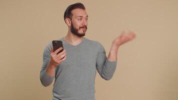 Man using smartphone typing new post on web, browsing, searching pointing empty advertisement space video