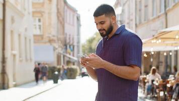 Tourist traveler young man guy using looking smartphone search a way on map in mobile navigator app video