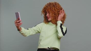 Child girl kid blogger taking selfie on smartphone communicating call online with subscribers video