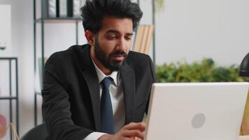 Inefficient tired lazy business man working sleeping on laptop computer with eyes stickers on face video