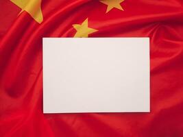 Top view of a blank white paper on the China flag background. photo
