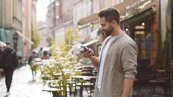 Tourist traveler young man guy using looking smartphone search a way on map in mobile navigator app video