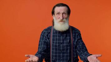 Elderly man raising hands in indignant expression, asking why, what reason of failure, irritation video