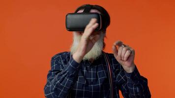 Elderly man using virtual reality VR app headset helmet to play simulation 3d 360 game drawing video