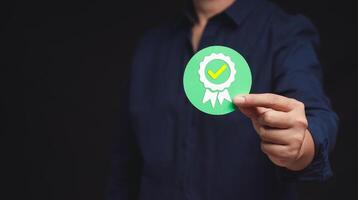 The best quality symbol assurance for a product, service, and ISO certification on a hand businessman. Space for text. photo