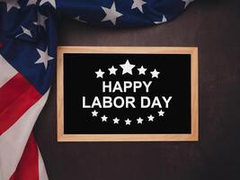 Part of the American flag and text of Happy Labor day on a mini chalkboard over the vintage background photo
