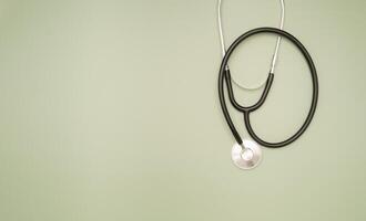 Top view of a stethoscope on a green background. Space for text. photo