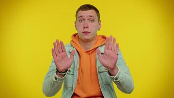 Man on yellow studio background pointing fingers himself ask say who me no thanks I do not need it video