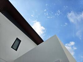 Bottom View of Minimal House with Blue Sky Background. photo