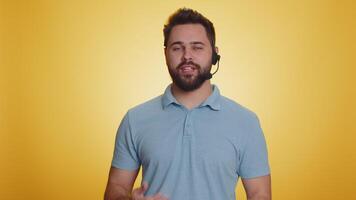 Man wearing headset, freelance worker, call center or support service operator helpline, having talk video