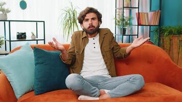 Confused middle eastern man feeling embarrassed about ambiguous question, having doubts, no idea video