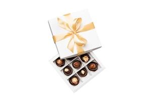 Chocolate candy in box with a colored bow. Gift box with Chocolates isolated on white top view photo