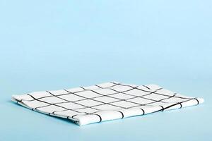 top view with white empty kitchen napkin isolated on table background. Folded cloth for mockup with copy space, style photo