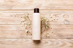 Fancy healthcare bottles for cream with gypsophila branch. Natural oranic spa cosmetics concept. Mockup, template, photo