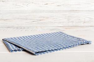 top view with blue kitchen napkin isolated table background. Folded cloth for mockup with copy space. Minimal style photo