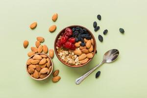 Cooking a wholesome breakfast. Granola with Various dried fruits and nuts in a bowl. The concept of a healthy dessert. Flat lay, top view copy space photo